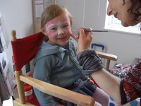 Girl having face painted at Glasdir