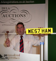 Auctioneer Gary Earle with the WE57 HAM registration plate which sold for Â£57,000 at auction.