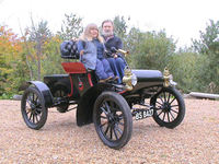 Joy Rainey and fellow adventurer, Trevor Hulks, aboard the venerable 1904 Oldsmobile