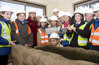 School children get first glimpse of historic stone coffin