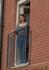 Rebecca Marshall looks out from the balcony of her new apartment