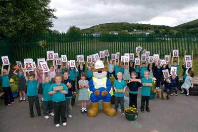 Students at Ystruth Primary School in East Pentwyn with Buster the Bear