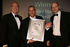 Ian Beal (centre), for Miller Homes, collects the trophy for Best Low or Zero Carbon Initiative