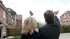 David and Anita Sines waving to their grandchildren across the fence at Cedar Place, Sunbury-on-Thames