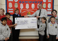 Louise Rees (TW) presents Adrian Byrne (Dan Y Graig Primary) with a giant cheque