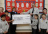 Louise Rees (TW) presents Adrian Byrne (Dan Y Graig Primary) with a giant cheque