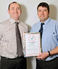 Paul Sweet (R), Miller Homes contracts manager, presents Steve Cooper (L) with his award. 