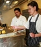 Arfan (Raz) Razak teaches a NCN student how to make an Onion Bhaji.