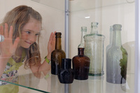 Alyce Edwards, aged seven, looking at bottles on display.