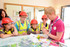 Rainbows, Brownies and Guides choose what to put in the time capsule.