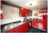 The Norbury’s eye-catching red gloss breakfasting kitchen.