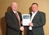 Construction manager Paul Cromby presents Tony Gordon with his award