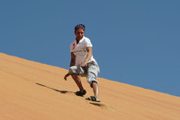 Dame Kelly Holmes tries sandboarding in Abu Dhabi