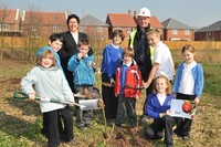 The children get stuck in to planting the trees