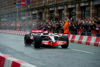 Jenson Button drives through Manchester in F1 car