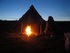 campfire outside of tipi at night