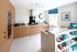 Kitchens boast tall cabinets and integrated appliances.