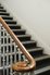 Restored fleur de lis wrought iron staircase  with oak handrail leading to apartments