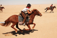 riding across the sands of Namibia