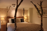 One of Cottage Lodge'#s beautiful hand-made beds One of Cottage Lodge'#s beautiful hand-made beds