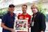 Sebastian Vettel with Keith Sutton and Mark Dickens with a limited edition Jochen Rindt print 