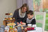 Mum and child decorate gingerbread men in the Redrow show homes at Priory Mews.